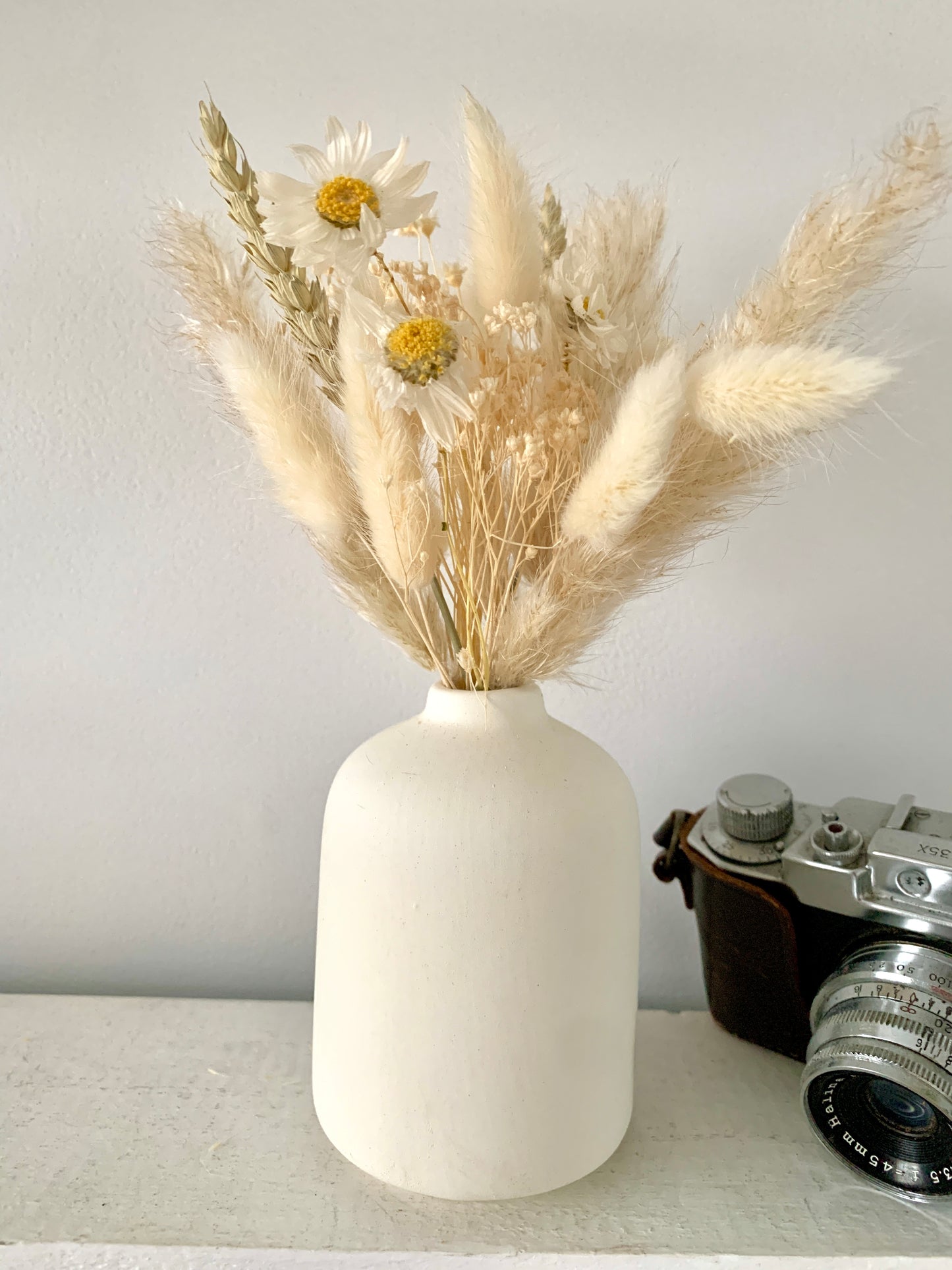 White ceramic vase and Daisy Bouquet